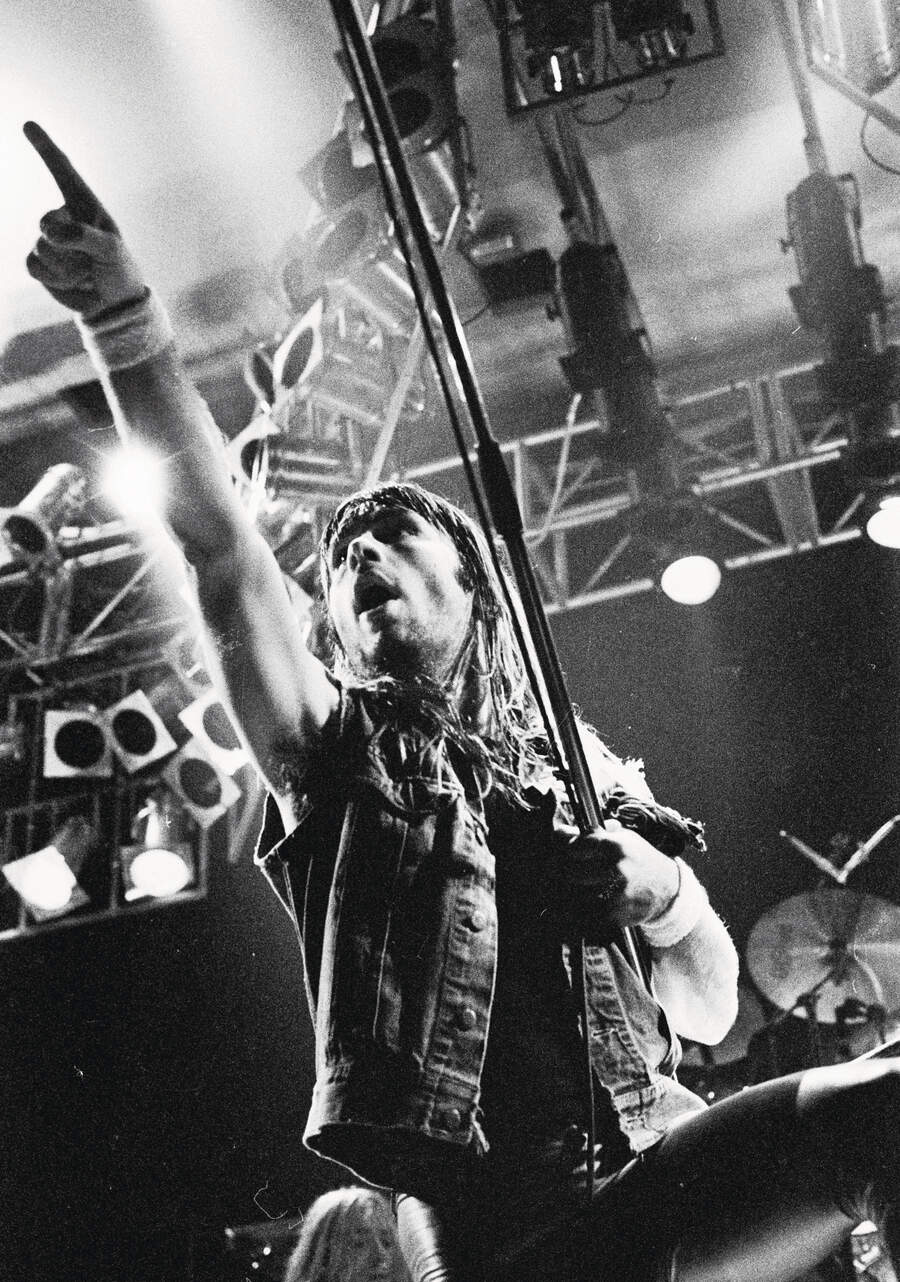 Bruce Dickinson onstage, pointing at the audience