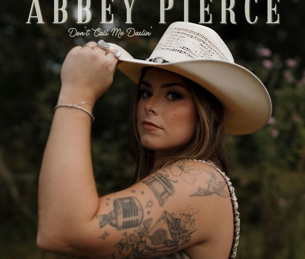 Vintage cowgirl woman with hat, tattoos, outdoor background, Abbey Pierce album cover, Don't Call Me Dullin.