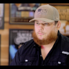 Sports fan with beard wearing baseball cap at Hall of Fans memorabilia store.