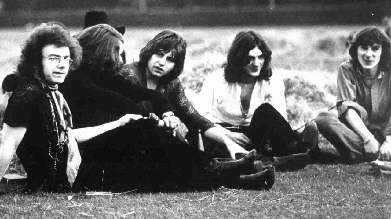 King Crimson posing for a photograph on grass in 1969