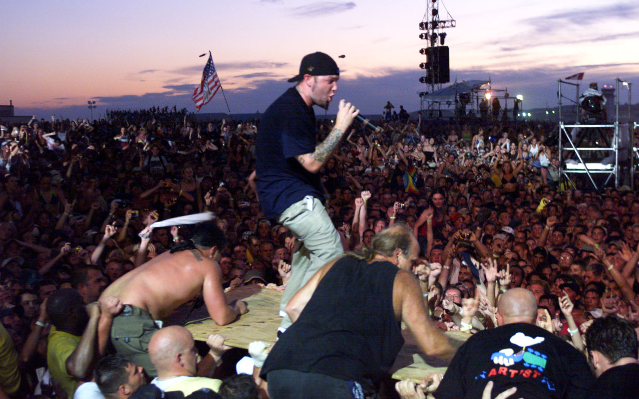 Fred Durst on a big piece of wood surfing across a crowd