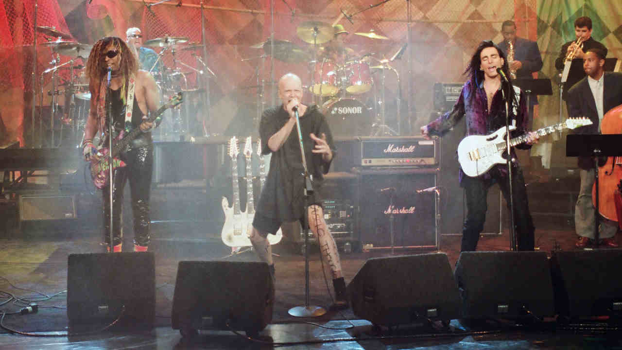 Devin Townsend and Steve Vai performing onstage in 1993