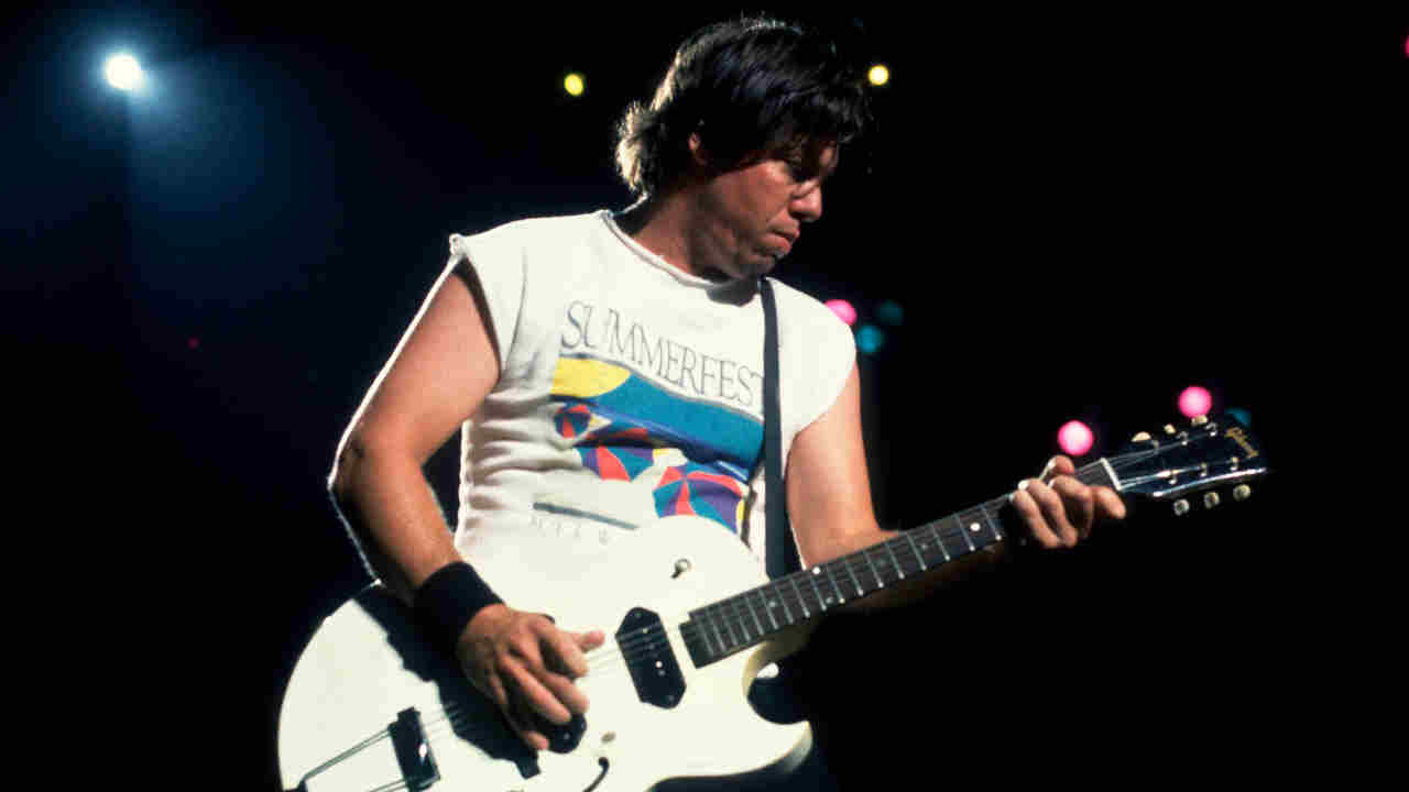 George Thorogood playing guitar onstage in the 1980s