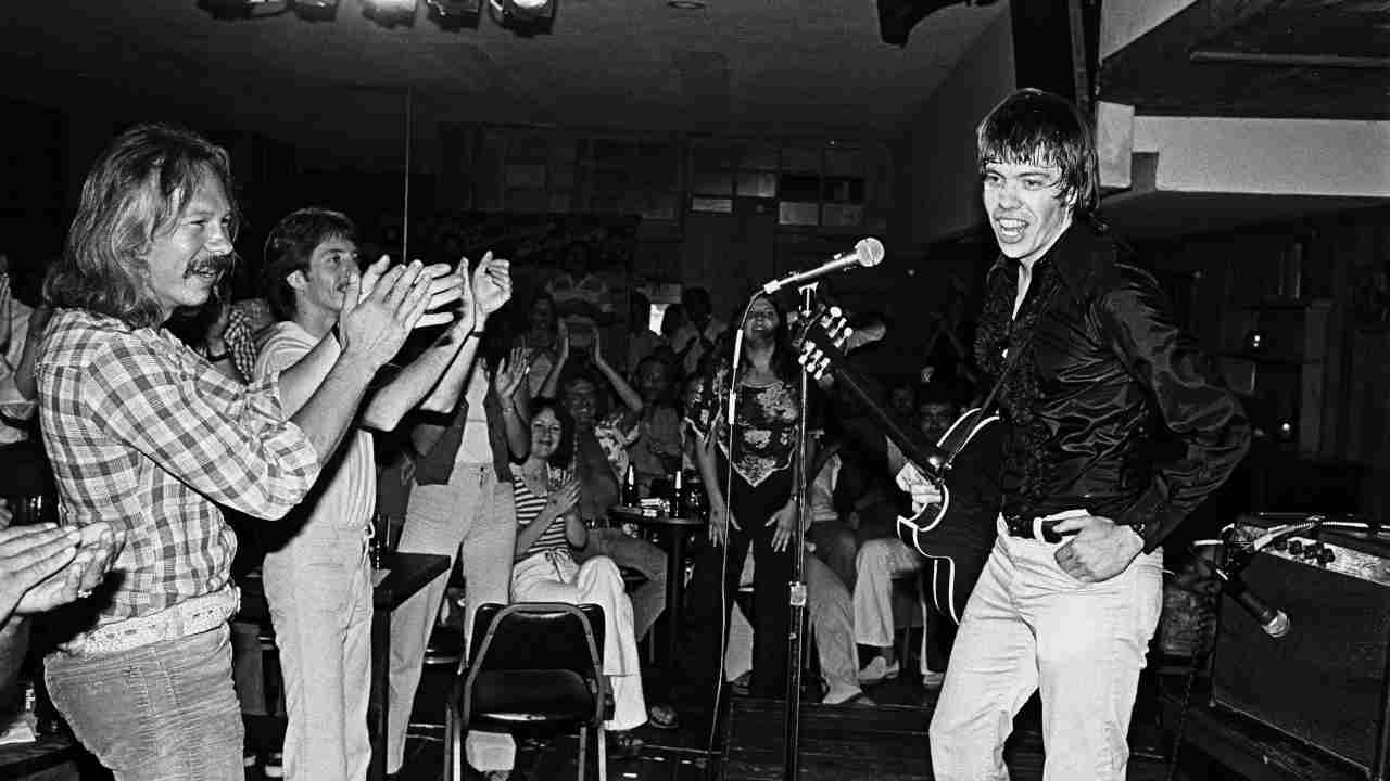 George Thorogood playing guitar onstage in 1978