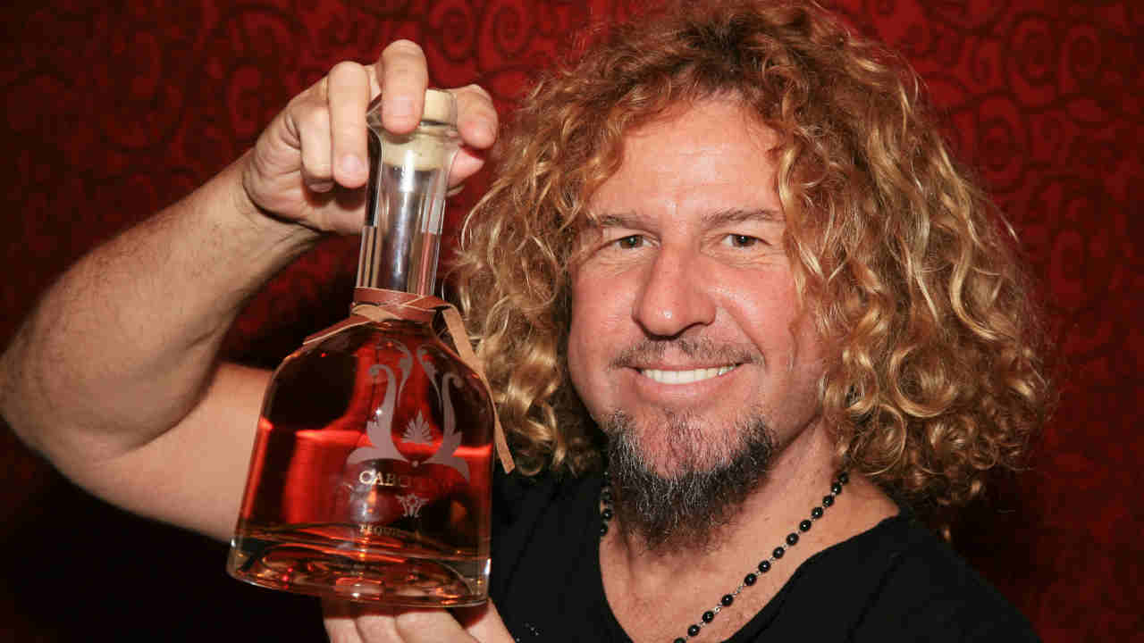 Sammy Hagar holding a bottle of Tequila