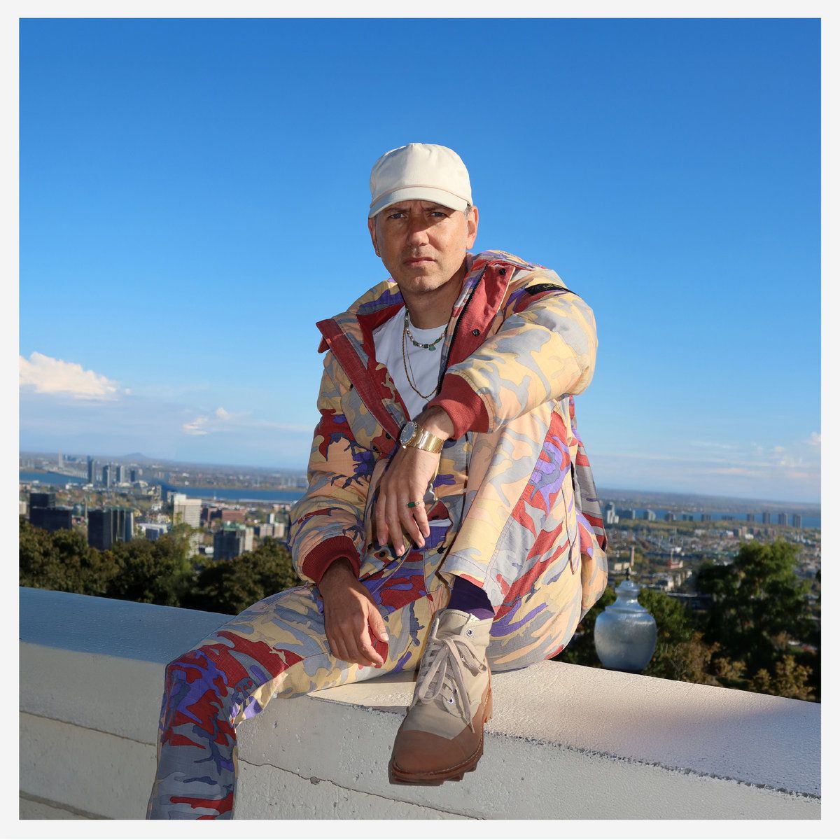 Image may contain Tiga Person Sitting Adult Face Head Clothing and Coat