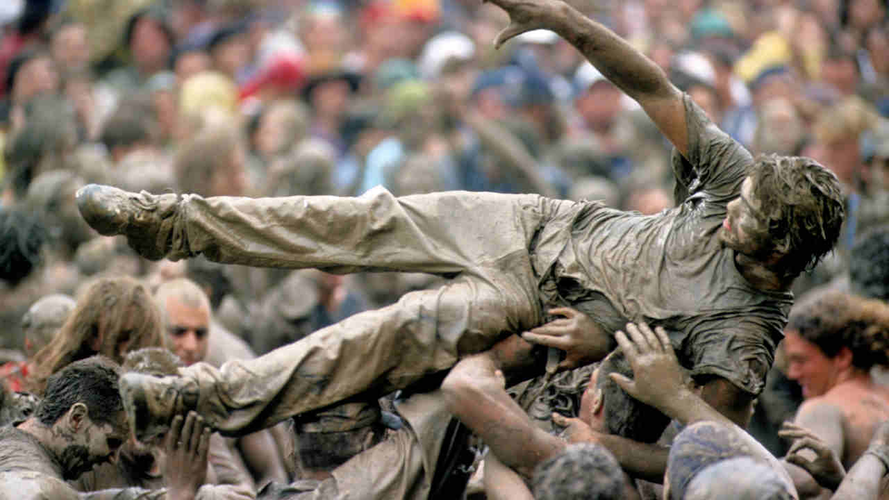 A man crowdsurfing at the Woodstock 94 festival