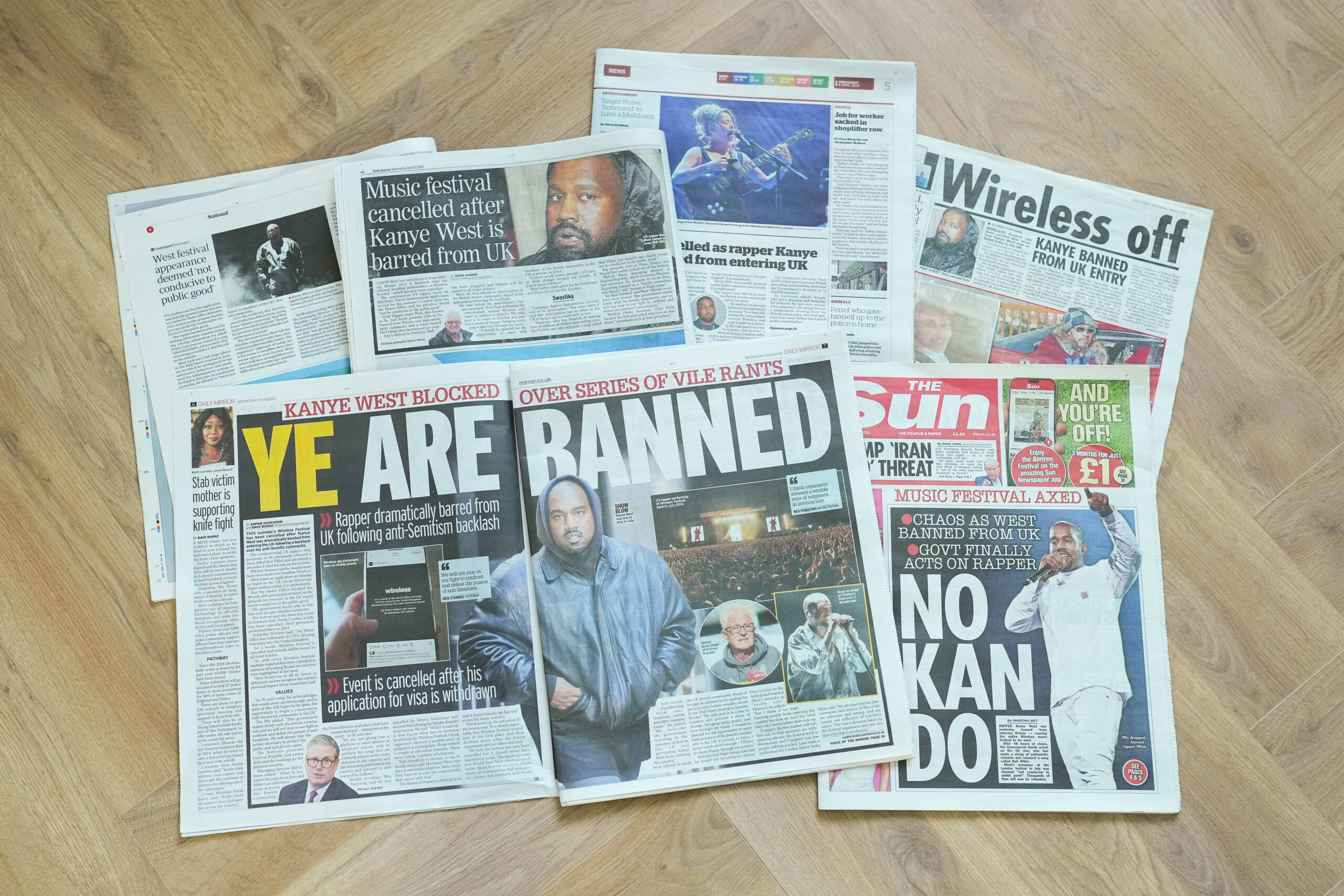 LONDON, ENGLAND - APRIL 8: In this photo illustration, UK newspaper front pages and articles display stories and images of Kanye West after he was blocked by the government from entering the UK on April 8, 2026 in London, England. The Wireless Festival has been cancelled after the UK Home Office confirmed that headline act Kanye West, also known as Ye, would be denied entry to the United Kingdom. The decision to book Ye as the headline act has been heavily criticised, due to the the rapper's antisemitic, racist and pro-Nazi comments. (Photo by Mark Case/Getty Images)