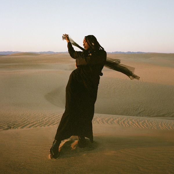 Image may contain Photography Adult Person Face Head Portrait Outdoors Nature Desert and Dancing