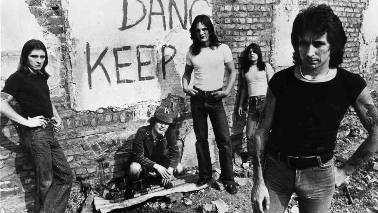 Bon Scott posing for a photograph with AC/DC