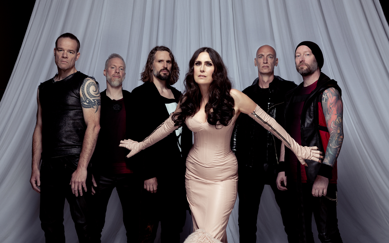 Within Temptation posing in front of a white curtain