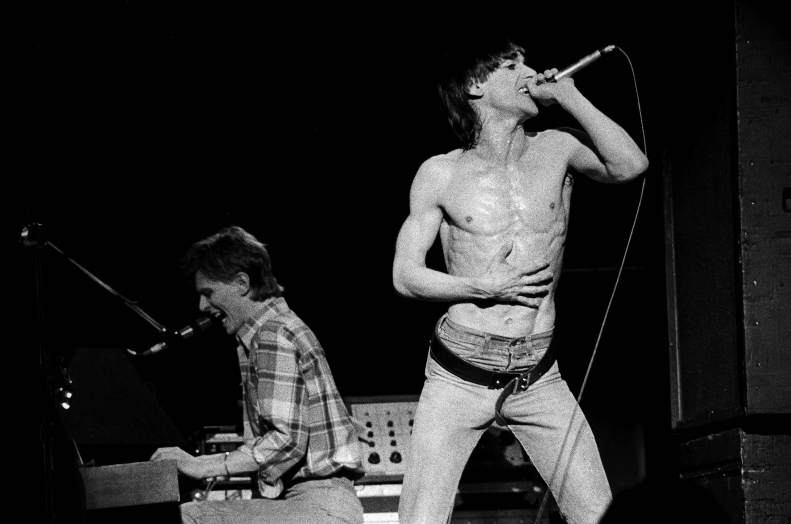 David Bowie performing onstage with Iggy Pop in 1977